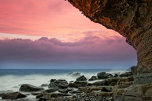 photo of rocks near sea HD wallpaper