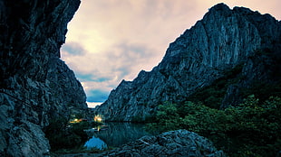 gray mountain and small body of water during daytime HD wallpaper
