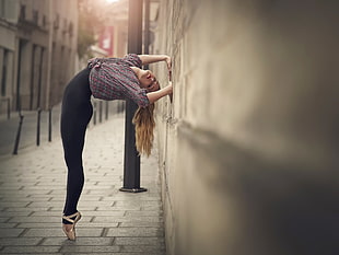 ballerina girl bending her body through wall