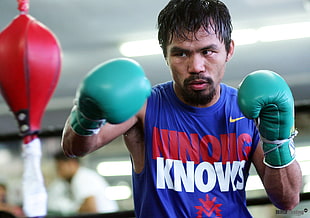 selective focus photography of Manny Pacquiao wearing punchinggloves