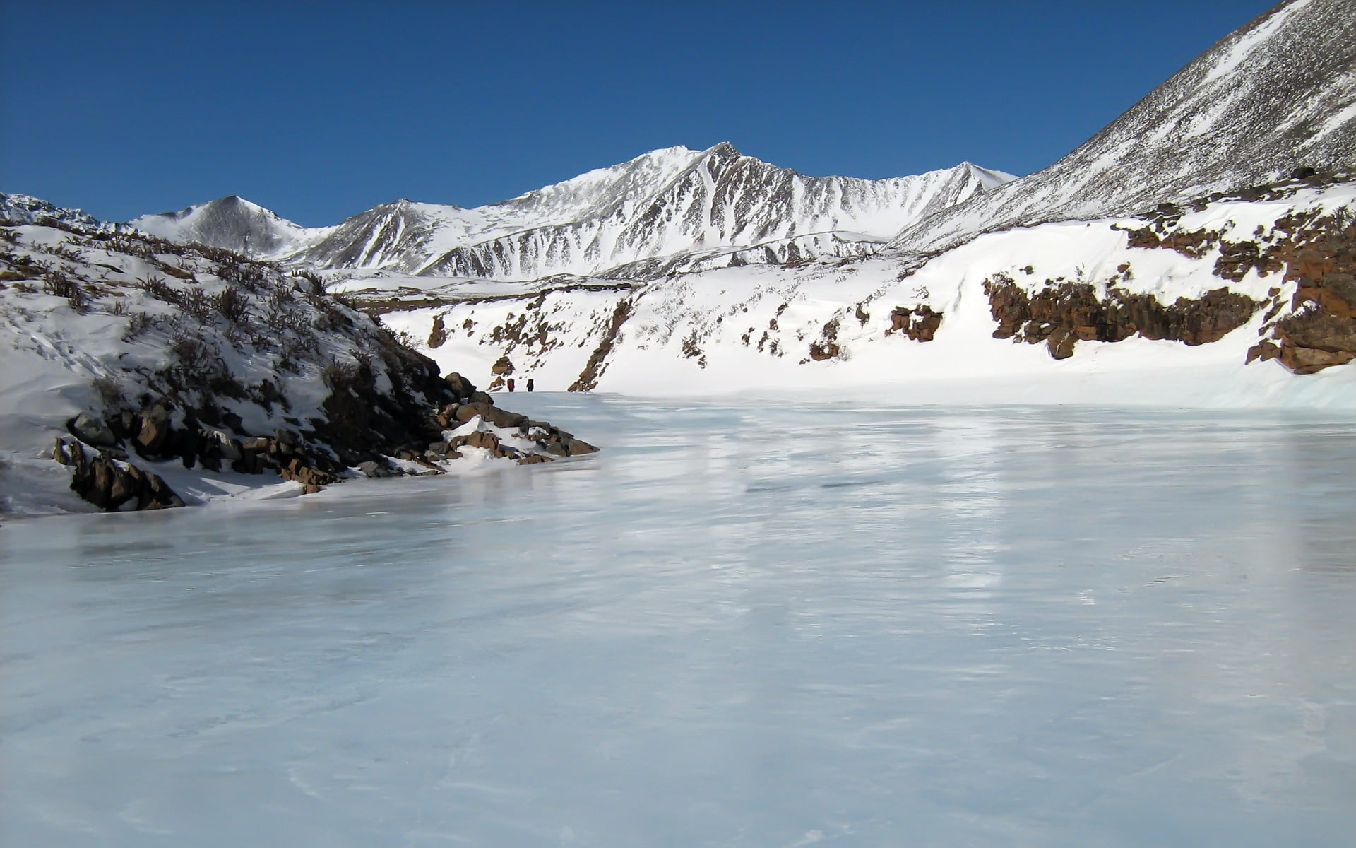 ice lake near snow covered mountains