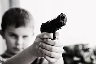 grayscale photography of a boy pointing pistol HD wallpaper