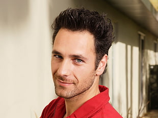 selective focus photography of man in red collared shirt