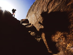person hiking a rocky area HD wallpaper