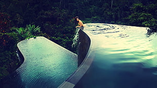 woman submerged in infinity pool