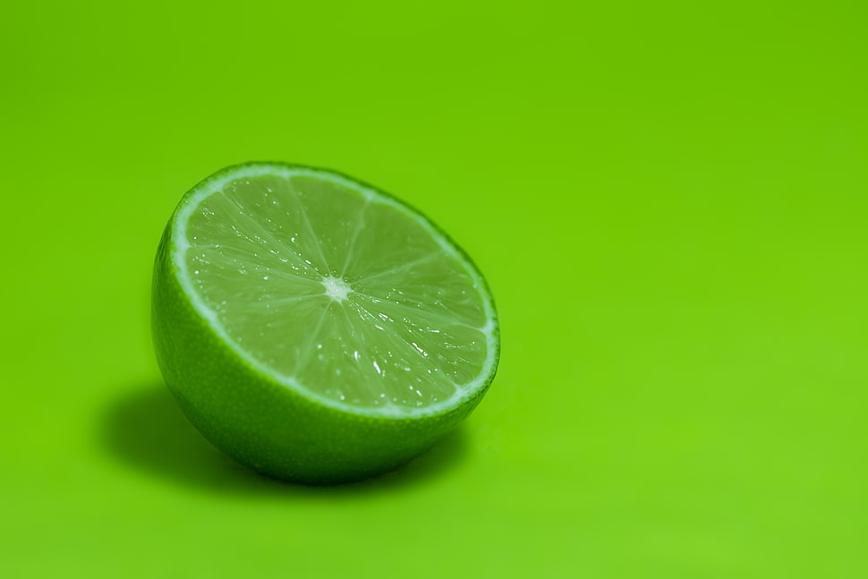 sliced green lime on wood HD wallpaper