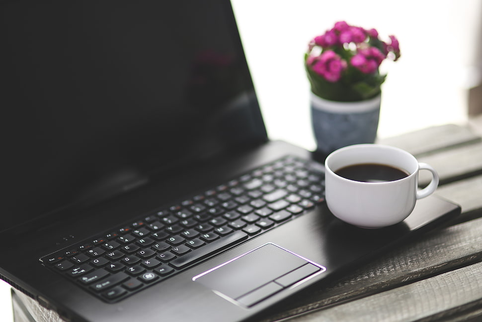 black laptop computer turned off with white ceramic cup HD wallpaper