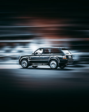 black 5-door hatchback in time lapse HD wallpaper