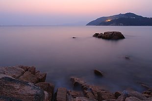 photo of rocks beside a sea HD wallpaper