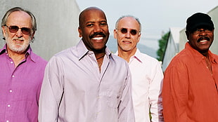 photo of four men wearing dress shirts