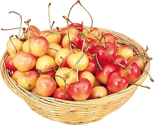 red cherries in brown wicker basket