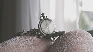 silver-colored pocket analog watch