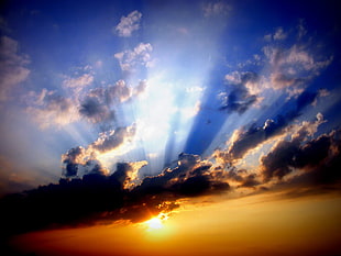 crepuscular ray of sun peeping on clouds