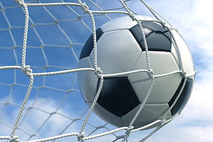 white and black soccer ball reached the goal net photo shot during daytime HD wallpaper