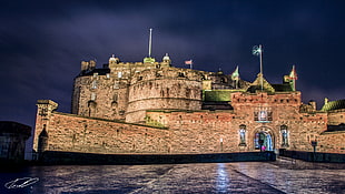 brown castle with flags under cloudy sky at night time, edinburgh castle HD wallpaper