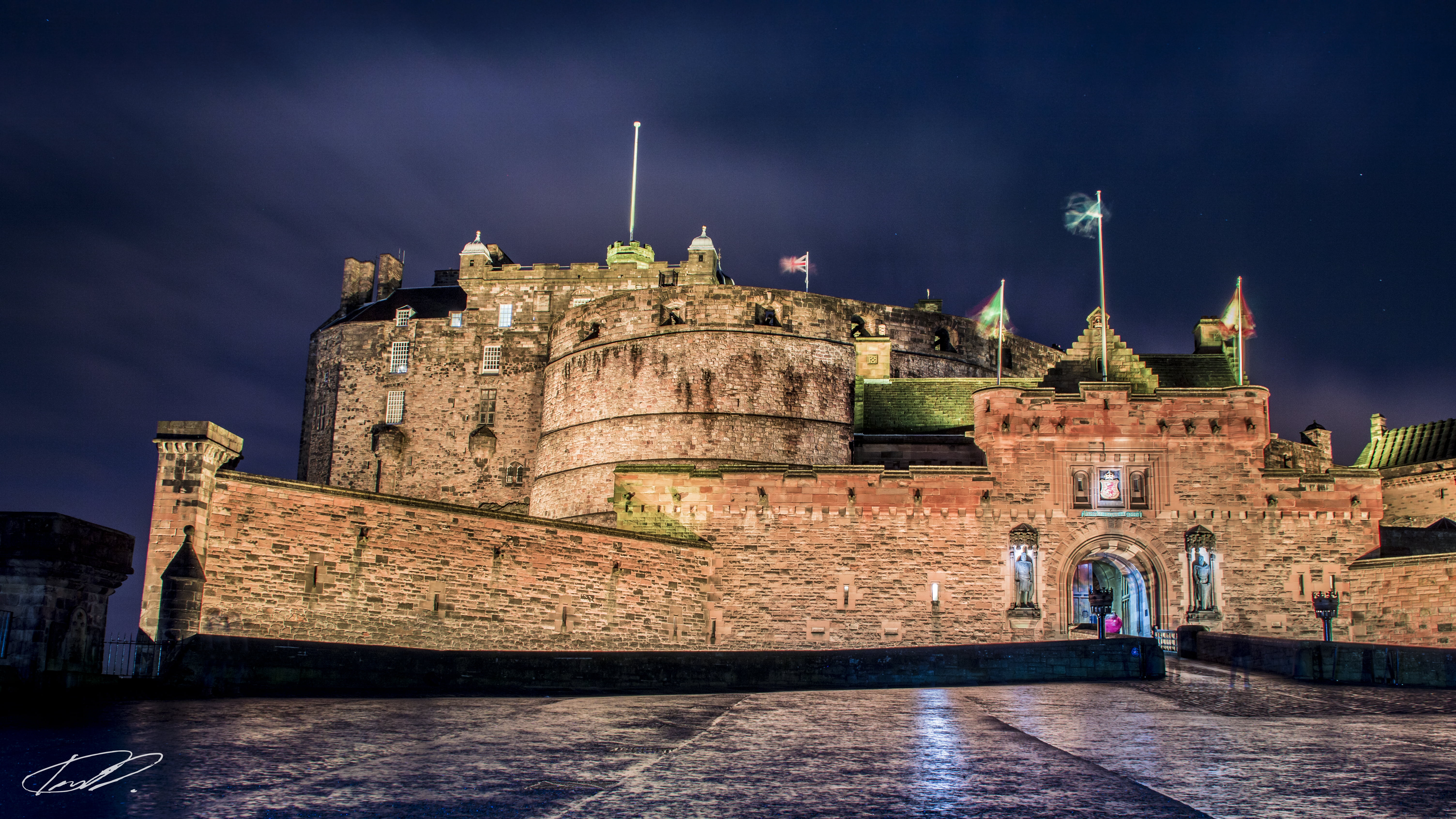 brown castle with flags under cloudy sky at night time, edinburgh castle