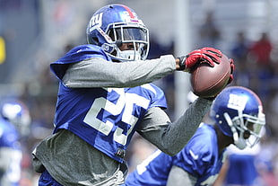 New York Giants player holding the ball
