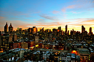 aerial photography of lighted buildings under blue and orange sky, manhattan HD wallpaper