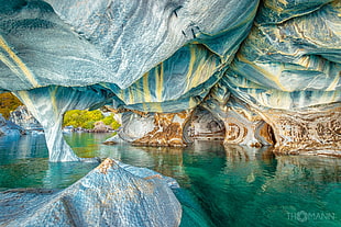 body of water and cave, cave, rocks