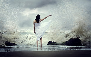 woman wearing white dress in front sea waves photo