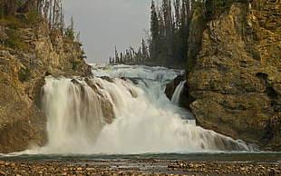 timelapse photography of waterfalls surrounded by rocks