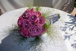 bouquet of pink roses on white table sheet