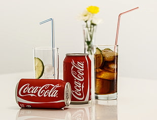 two Coca-Cola soda cans