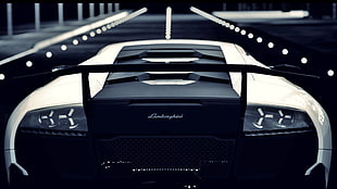 white and black Lamborghini Murcielago running on road