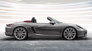 side-view of silver convertible coupe on white background