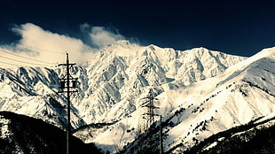 snowcap mountain with electric posts