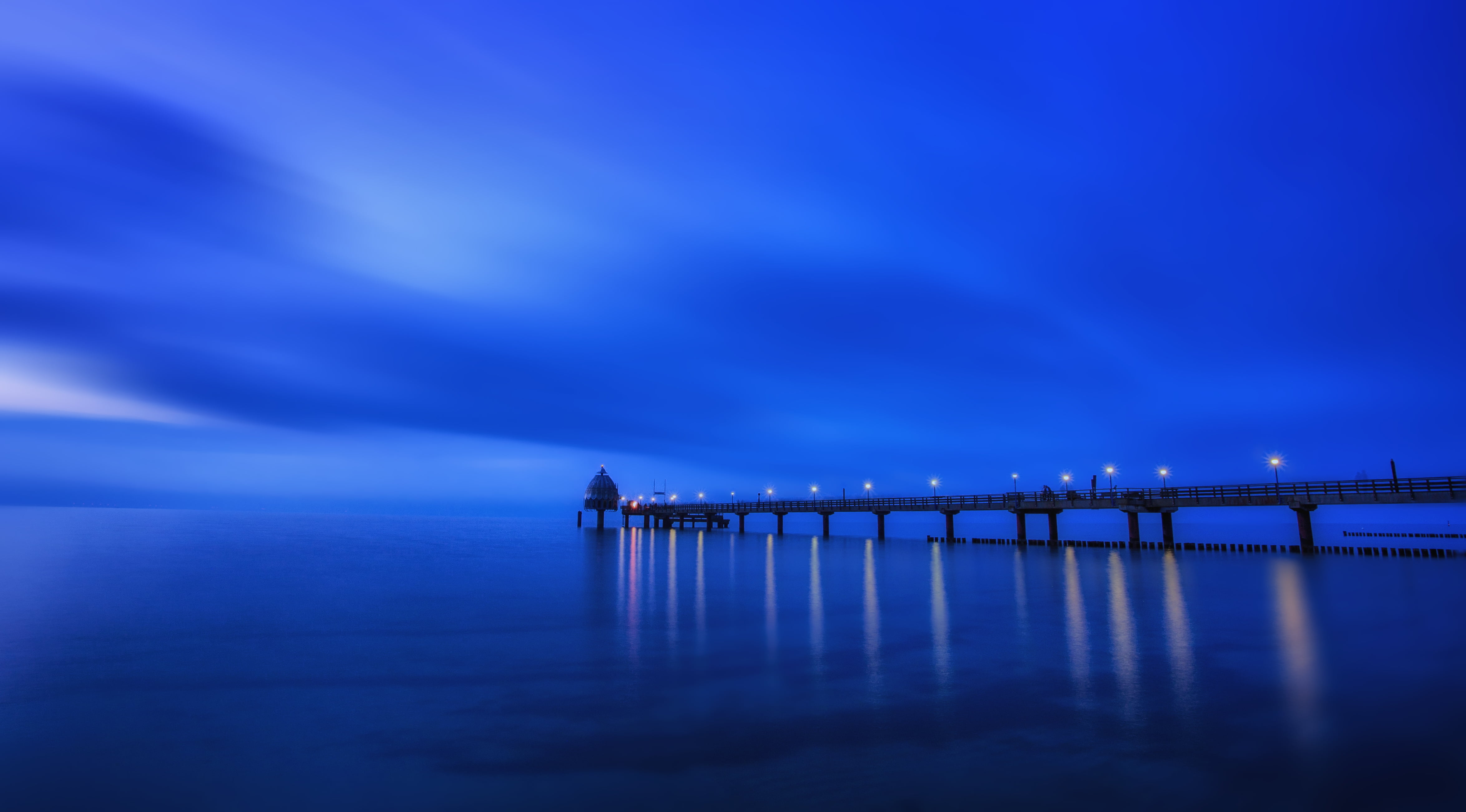 dock near body of water during night time