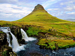 time-lapse photo of water falls near to perfect cone mountain, iceland