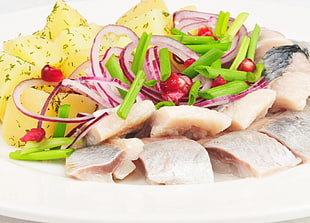 closeup photography of raw fish with slice of onion and spring onion with pineapple fruit