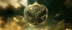 brass-colored butterfly emblem, Tomorrowland