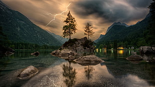 gray rock, trees, water, clouds, lightning