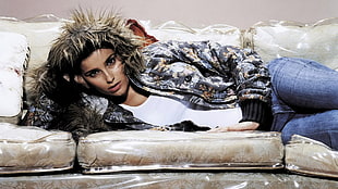 woman wearing hoodie lying on sofa