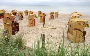 brown wicker basket near brown sand beside seashore during daytime