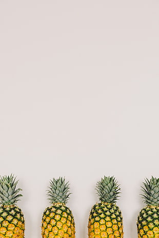 four yellow pineapples