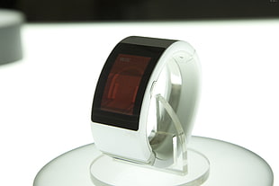 white smart watch on clear plastic stand