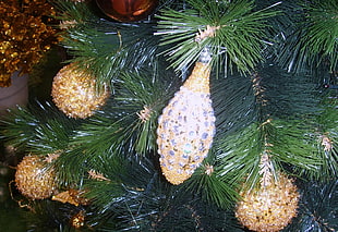 gold and silver baubles in green Christmas tree