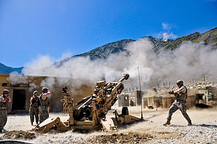 four soldier using cannon