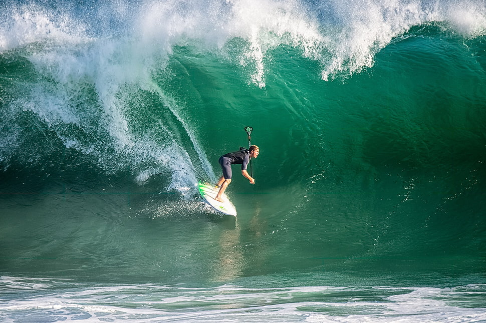 woman surfing on waves during daytime HD wallpaper