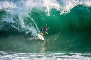 woman surfing on waves during daytime