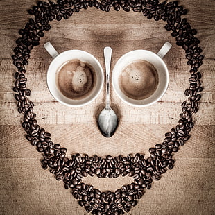 skull shape form from coffee beans , mugs and table spoon