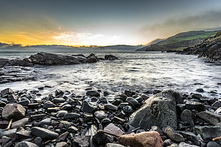 photo of rock formation near body of water, northern ireland HD wallpaper