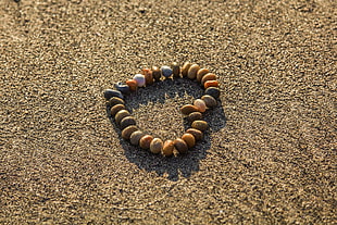 heart framed stones on brown sand