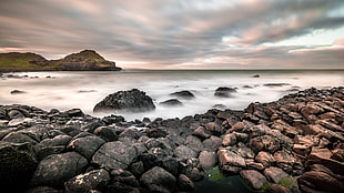 pile of rocks near body of water with mountain view, northern ireland HD wallpaper