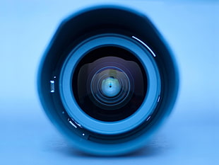 closeup photo of black and white lens in blue background