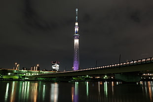 landscape photo of a lighted tower and bridge