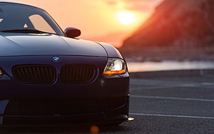 closeup photography of black BMW Z4 Roadster during golden hour